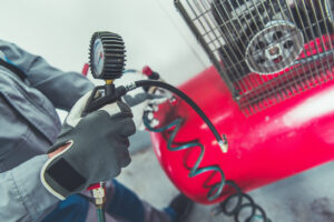 Man servicing air compressor.